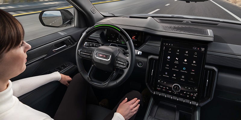 2025 GMC Acadia woman driving with view of large digital display
