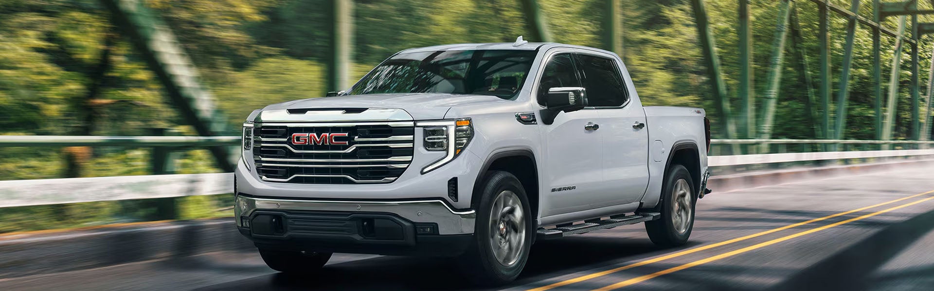 GMC Sierra 1500 pickup truck driving on road